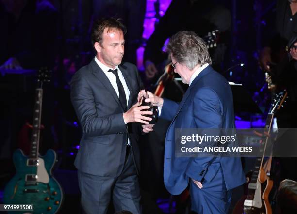 Songwriters Hall of Fame Inductee US songwriter Steve Dorff accepts his award from his son actor Stephen Dorff onstage during the Songwriters Hall of...