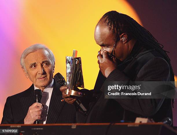 Singer Stevie Wonder receives an award of honor for his career from from singer Charles Aznavour during the 25th Victoires de la Musique yearly...