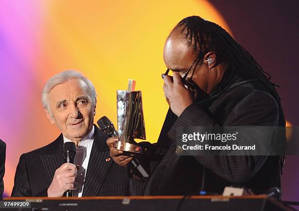 Singer Stevie Wonder receives an award of honor for his career from from singer Charles Aznavour during the 25th Victoires de la Musique yearly...
