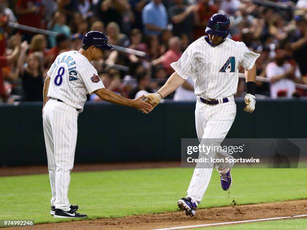 Arizona Diamondbacks first baseman Paul Goldschmidt gives a high five to Arizona Diamondbacks third base coach Tony Perezchica after hitting a homer...