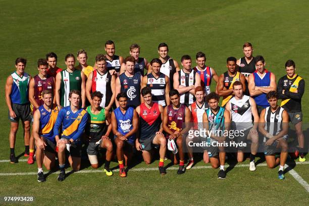 Suns players pose wearing their junior club guernsey during a Gold Coast Suns AFL training session at Metricon Stadium on June 15, 2018 in Gold...