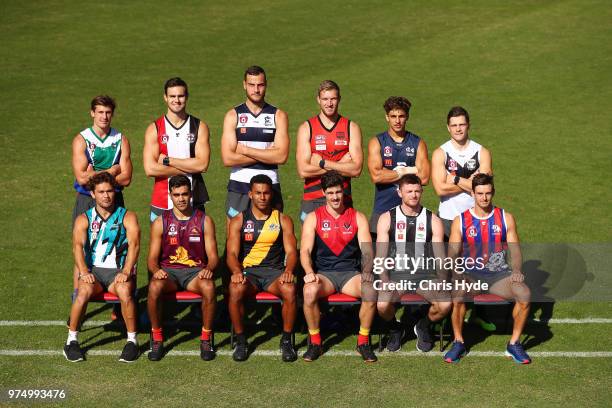 Suns players pose wearing their junior club guernsey during a Gold Coast Suns AFL training session at Metricon Stadium on June 15, 2018 in Gold...