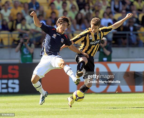 Tony Lochhead of the Phoenix is tackled by Jin-Hyung Song of the Jets during the A-League Minor Semi Final match between the Wellington Phoenix and...