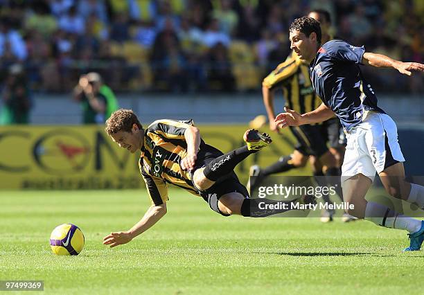 Tony Lochhead of the Phoenix is tackled by Adam D'Apuzzo of the Jets during the A-League Minor Semi Final match between the Wellington Phoenix and...