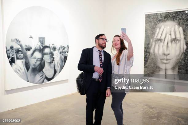 Guests attend the Tigran Tsitoghdzyan "Uncanny" show at Allouche Gallery on June 14, 2018 in New York City.