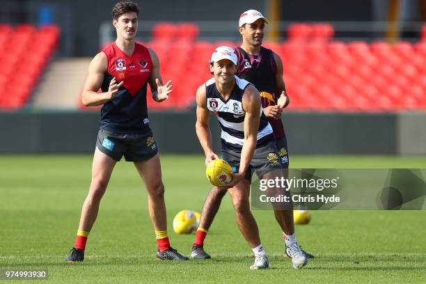 Lachie Weller handballs during a Gold Coast Suns AFL training session at Metricon Stadium on June 15, 2018 in Gold Coast, Australia.