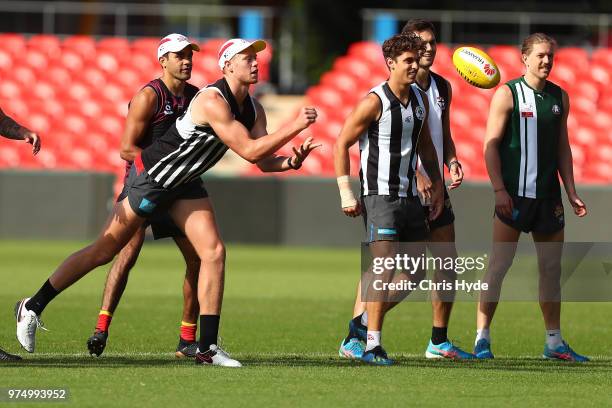 Peter Wright handballs during a Gold Coast Suns AFL training session at Metricon Stadium on June 15, 2018 in Gold Coast, Australia.