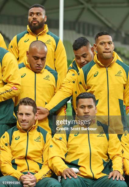 Taniela Tupou of the Wallabies gestures towards Bernard Foley of the Wallabies as Israel Folau of the Wallabies looks on at the team photo during an...