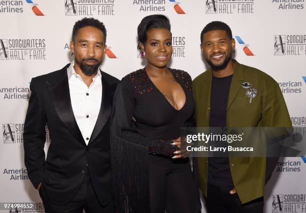 Johnta Austin, Fantasia, and Usher Raymond pose backstage during the Songwriters Hall of Fame 49th Annual Induction and Awards Dinner at New York...