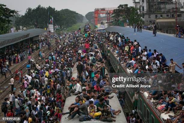 Bangladeshi Muslims climb on overcrowded trains to travel home for Eid al-Fitr on June 15, 2018 in Dhaka, Bangladesh. Muslims around the world...