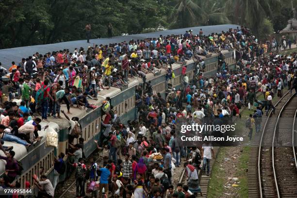 Bangladeshi Muslims climb on overcrowded trains to travel home for Eid al-Fitr on June 15, 2018 in Dhaka, Bangladesh. Muslims around the world...