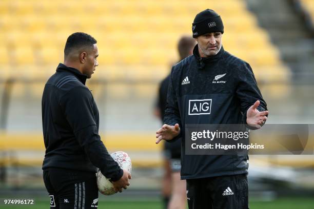 Assistant Coach and former All Black Scott McLeod speaks to Ngani Laumape during the New Zealand All Blacks Captain's Run at Westpac Stadium on June...