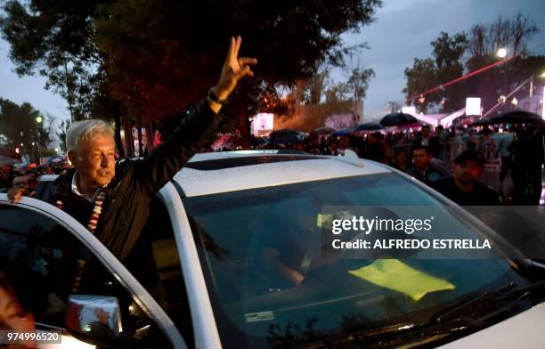 Mexican presidential candidate for the MORENA party, Andres Manuel Lopez Obrador greets supporters, after a campaign rally in Chimalhuacan, State of...