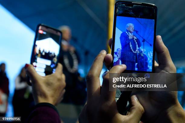 Supporter of Mexican presidential candidate for the MORENA party, Andres Manuel Lopez Obrador, takes a picture of him during a campaign rally in...