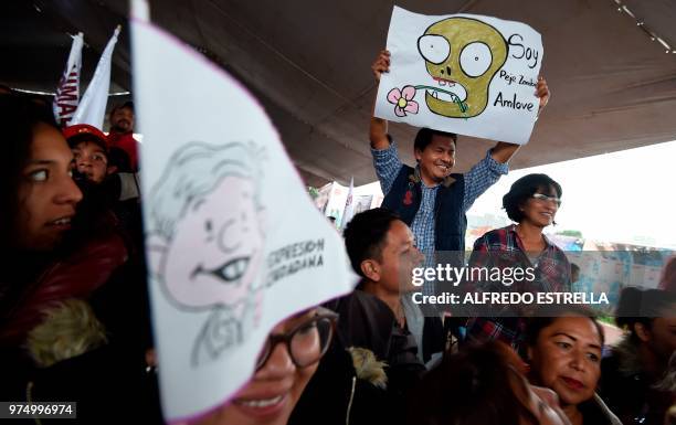 Supporter of Mexican presidential candidate for the MORENA party, Andres Manuel Lopez Obrador, holds a sign during a campaign rally in...