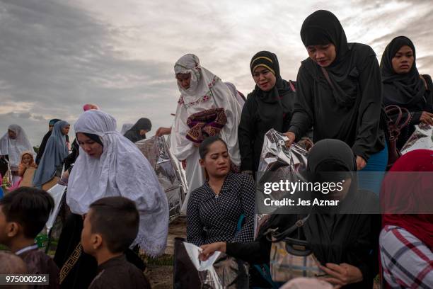 Filipino Muslims flock to a public park to attend prayers and celebrate Eid al-Fitr on June 15, 2018 in Manila, Philippines. Muslims around the world...