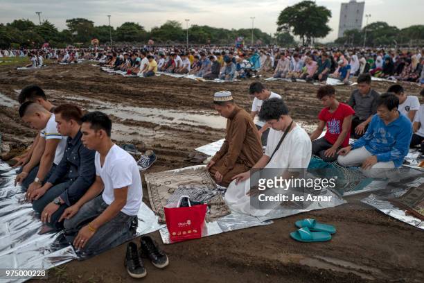 Filipino Muslims flock to a public park to attend prayers and celebrate Eid al-Fitr on June 15, 2018 in Manila, Philippines. Muslims around the world...