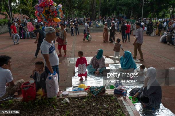 Filipino Muslims flock to a public park to attend prayers and celebrate Eid al-Fitr on June 15, 2018 in Manila, Philippines. Muslims around the world...