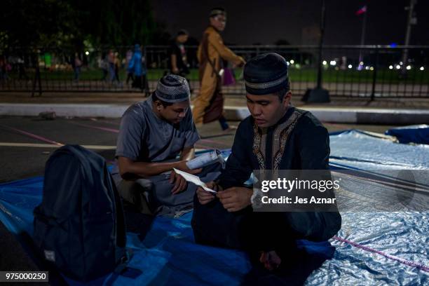 Filipino Muslims flock to a public park to attend prayers and celebrate Eid al-Fitr on June 15, 2018 in Manila, Philippines. Muslims around the world...