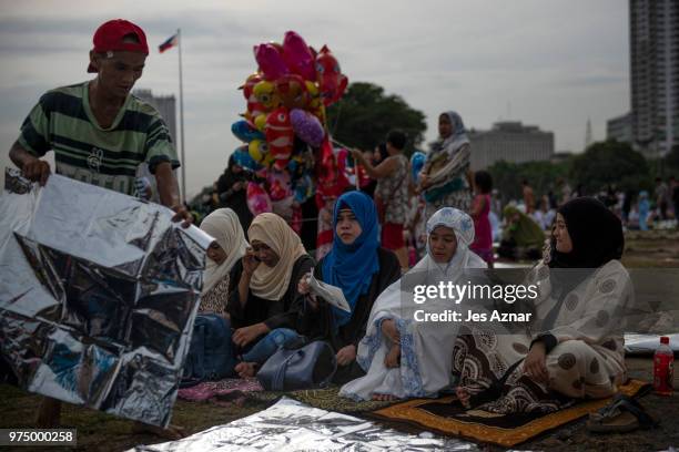 Filipino Muslims flock to a public park to attend prayers and celebrate Eid al-Fitr on June 15, 2018 in Manila, Philippines. Muslims around the world...