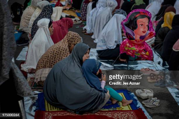 Filipino Muslims flock to a public park to attend prayers and celebrate Eid al-Fitr on June 15, 2018 in Manila, Philippines. Muslims around the world...