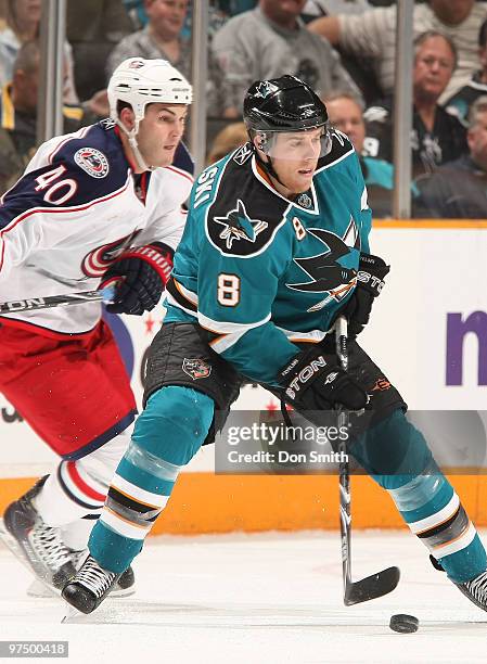 Jared Boll of the Columbus Blue Jackets watches the puck against Joe Pavelski of the San Jose Sharks during an NHL game on March 6, 2010 at HP...