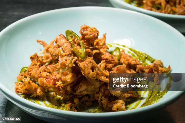 Calamarcitos, crispy baby calamari with spiced herb aioli and pickled green chilli, is prepared at Ola Cocina del Mar in Singapore, on Thursday, June...