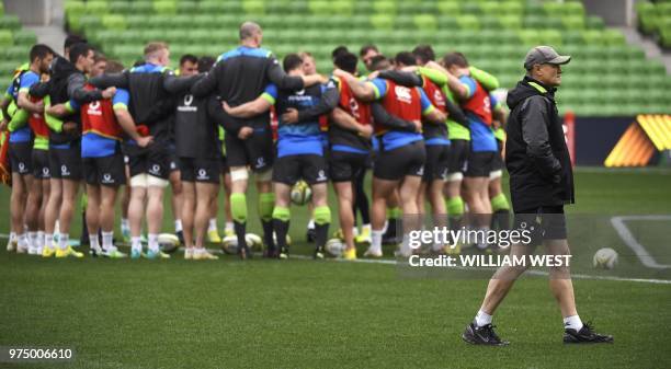 Ireland's rugby team coach Joe Schmidt walks past the team huddle during the captain's run training session in Melbourne on June 15 ahead of the...