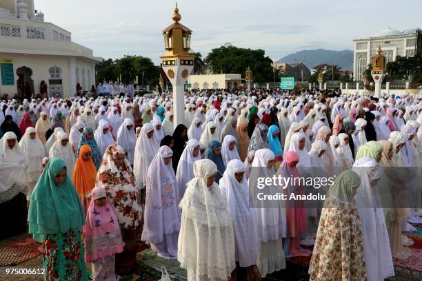 Muslims perform Eid al-Fitr prayer at Baiturrahman Grand Mosque, Aceh, Indonesia on June 15, 2018. Eid al-Fitr is a religious holiday celebrated by...