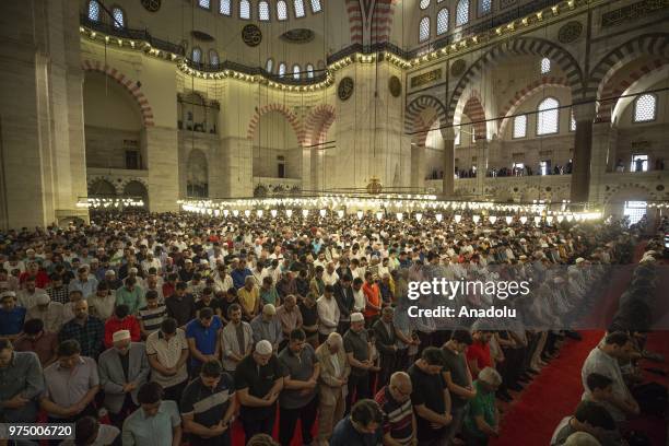 Muslims perform Eid al-Fitr prayer at Suleymaniye Mosque in Istanbul, Turkey on June 15, 2018. Eid al-Fitr is a religious holiday celebrated by...