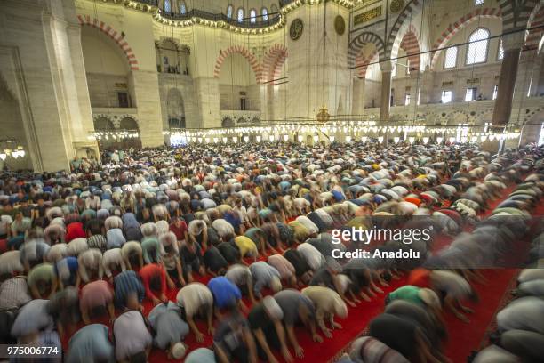 Muslims perform Eid al-Fitr prayer at Suleymaniye Mosque in Istanbul, Turkey on June 15, 2018. Eid al-Fitr is a religious holiday celebrated by...