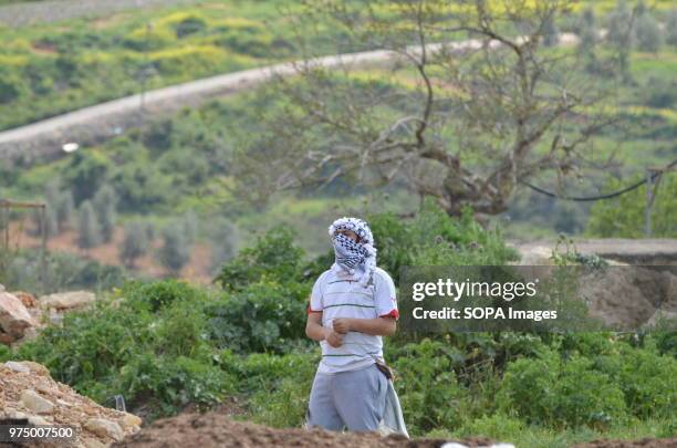 Palestinian protester prepares his sling shot during the Friday protests. Nabi Saleh is a village in Palestine which regularly protests the...