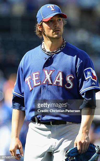 Relief pitcher C.J. Wilson of the Texas Rangers walks off the field during the MLB spring training game against the Kansas City Royals at Surprise...