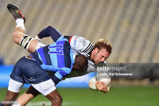 Mitchell Dunshea of the Crusaders is tackled by Djibril Camara of the French Barbarians during the match between the Crusaders and the French...
