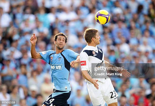 Adrian Leijer of the Victory heads the ball in front of Alex Brosque of Sydney during the A-League Major Semi Final match between Sydney FC and...