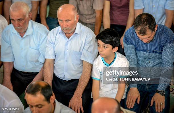 Azerbaijani Muslims pray at the mosque of Tezeh Pir in Baku on June 15 during celebrations of Eid al-Fitr marking the end of the Muslim fasting month...