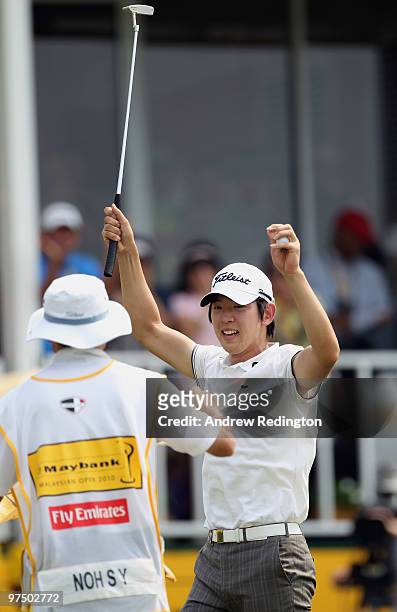 Noh Seung-yul of Korea celebrates with his caddie on the 18th green after winning the Maybank Malaysian Open at the Kuala Lumpur Golf and Country...
