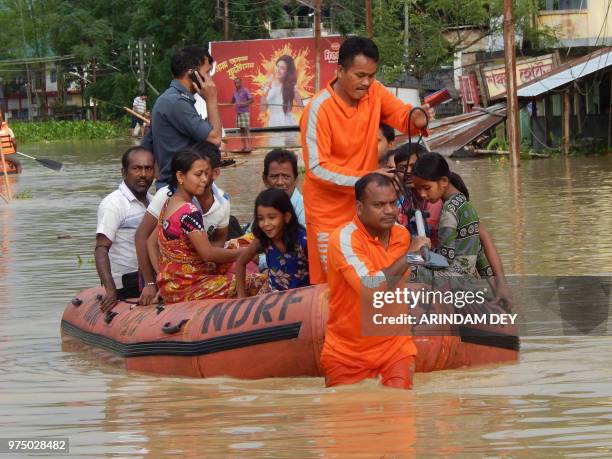 In this picture taken on on June 14 National Disaster Response Force personnel rescue Indian residents at Kailasahar, some 156 kms north of Agartala,...