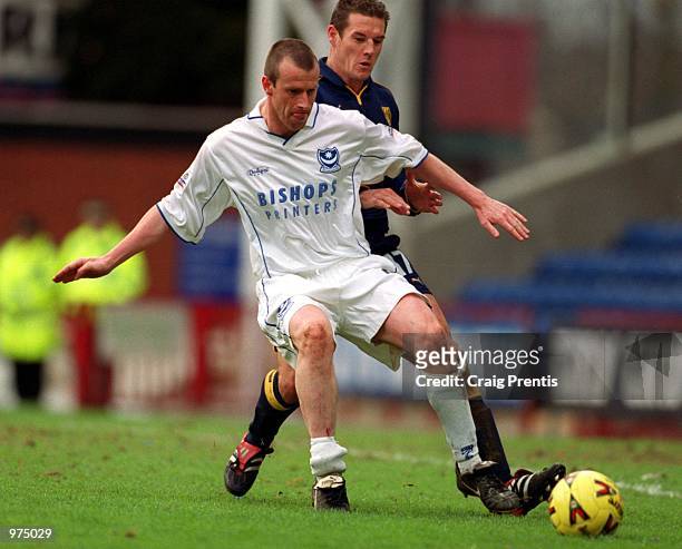 Portsmouth manager Steve Claridge is challenged by Mark Williams of Wimbeldon during the Nationwide League Division One match between Wimbledon and...