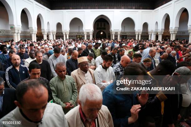 Muslims pray at the Grande Mosquee de Paris in Paris at the start of the Eid al-Fitr holiday which marks the end of Ramadan, on June 15, 2018.