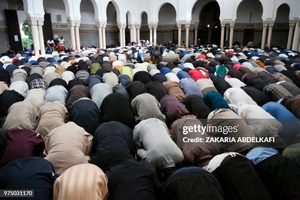 Muslims pray at the Grande Mosquee de Paris in Paris at the start of the Eid al-Fitr holiday which marks the end of Ramadan, on June 15, 2018.