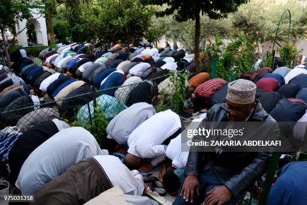 Muslims pray at the Grande Mosquee de Paris in Paris at the start of the Eid al-Fitr holiday which marks the end of Ramadan, on June 15, 2018.