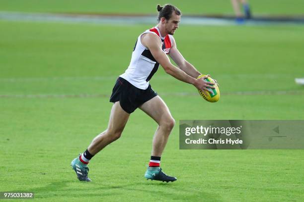 Daniel McKenzie kicks during a St Kilda Saints AFL training session at Metricon Stadium on June 15, 2018 in Gold Coast, Australia.