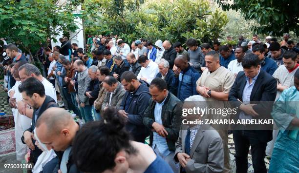 Muslims pray at the Grande Mosquee de Paris in Paris at the start of the Eid al-Fitr holiday which marks the end of Ramadan, on June 15, 2018.