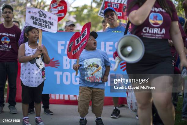 Young children alongside adults protest the Trump administration policy of removing children from parents arrested for illegally crossing the...