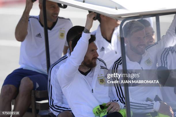 Argentina's forward Lionel Messi , defender Cristian Ansaldi and midfielder Javier Mascherano arrive to a training session at the team's base camp in...