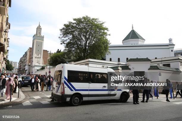 Police officers stand guard outside the Grande Mosquee de Paris in Paris at the start of the Eid al-Fitr holiday which marks the end of Ramadan, on...