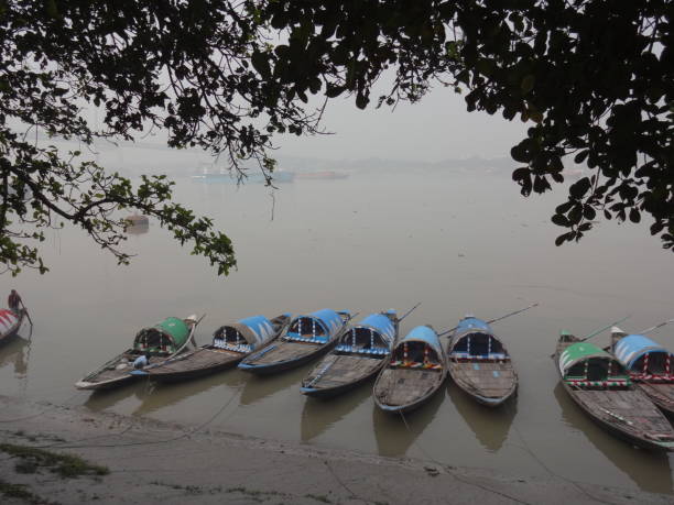 boats moored on coast, princep ghat, ganges, kolkata, india - kolkata ganga aerial view stock pictures, royalty-free photos & images