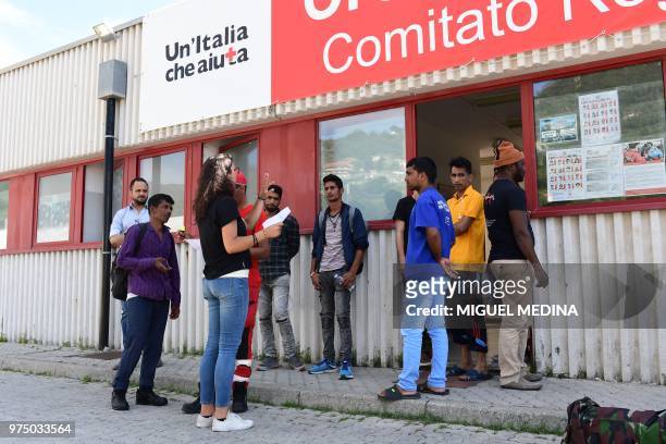 Migrants listen to a volunteer at the Italian Red Cross camp in Ventimiglia, northern Italy, on June 15, 2018.