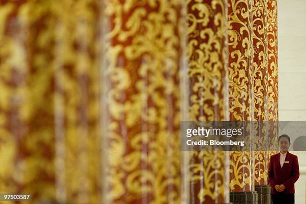 An attendant stands on duty during a news conference held by Yang Jiechi, foreign minister for China, unseen, at the Great Hall of the People in...